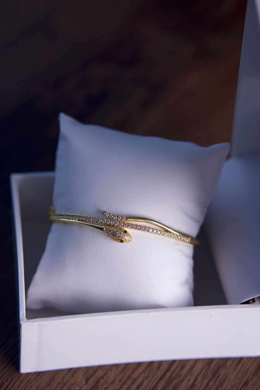 Gold bracelet with diamonds on a white pillow