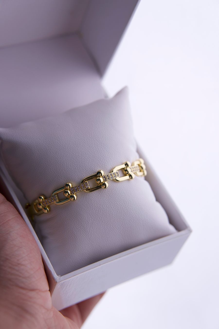 Gold bracelet in a white gift box