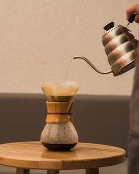 Artistic capture of pouring water into a Chemex for a perfect brew.