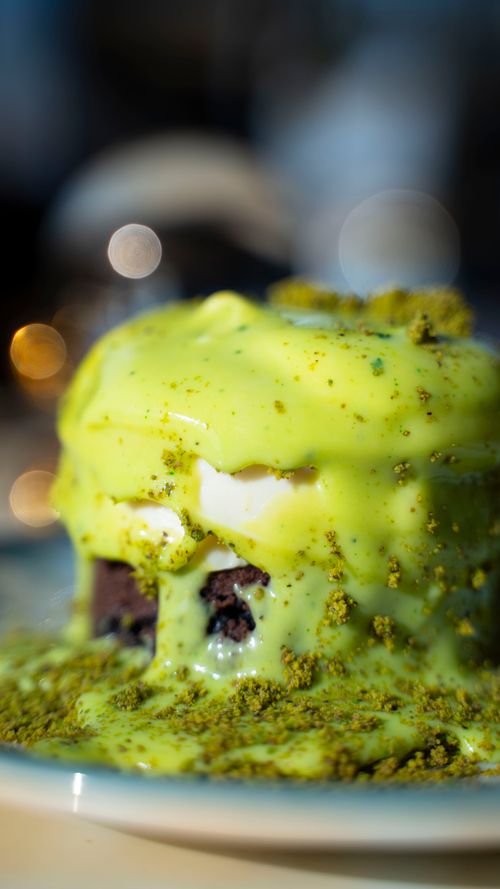 Free Appetizing dessert topped with bright matcha sauce, perfect for sweet tooth enthusiasts. Stock Photo