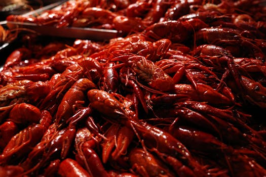 A close-up view of fresh red lobsters piled together, showcasing their vibrant color and texture.