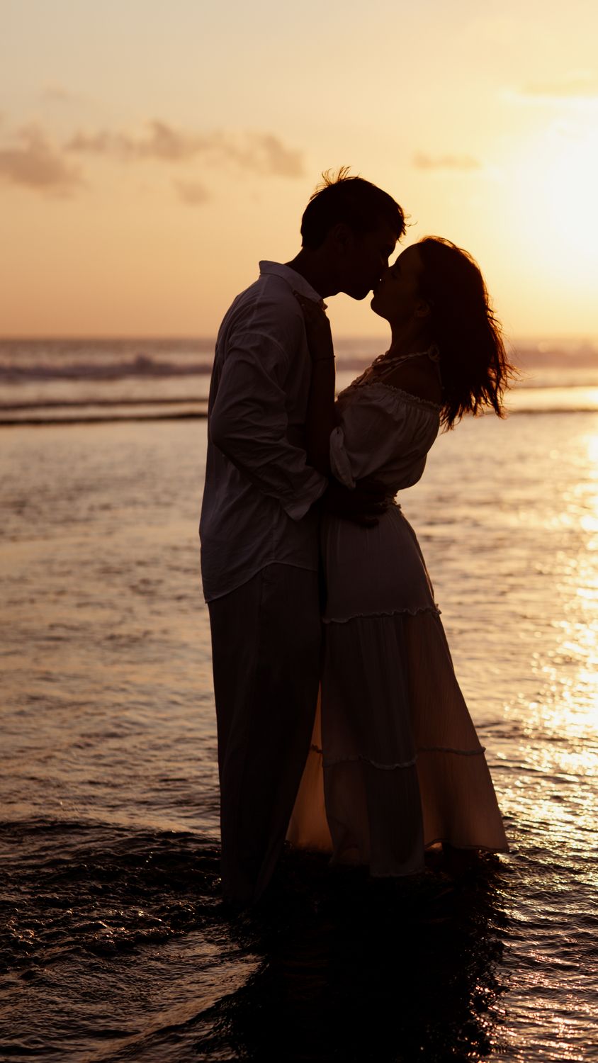 Romantic Couple Embracing at Sunset Beach · Free Stock Photo