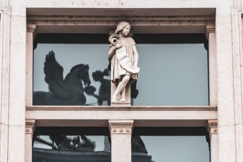 Free Sculpture in window frame reflecting mythical Pegasus statue Stock Photo