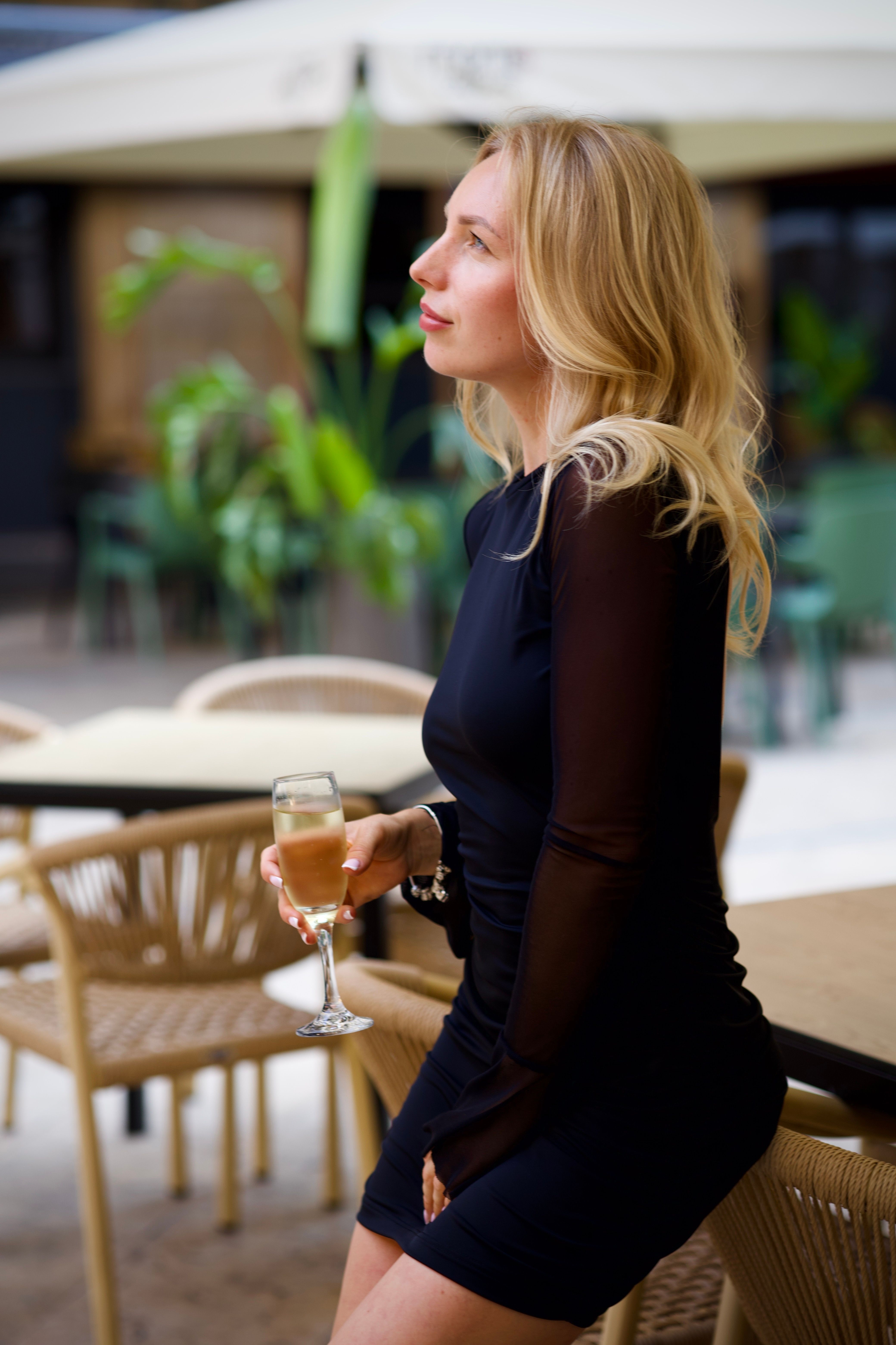 in my little black dress sipping champagne Shine Bright: My Sparkling Nude Rhinestone Mini Dress for NYE & Club