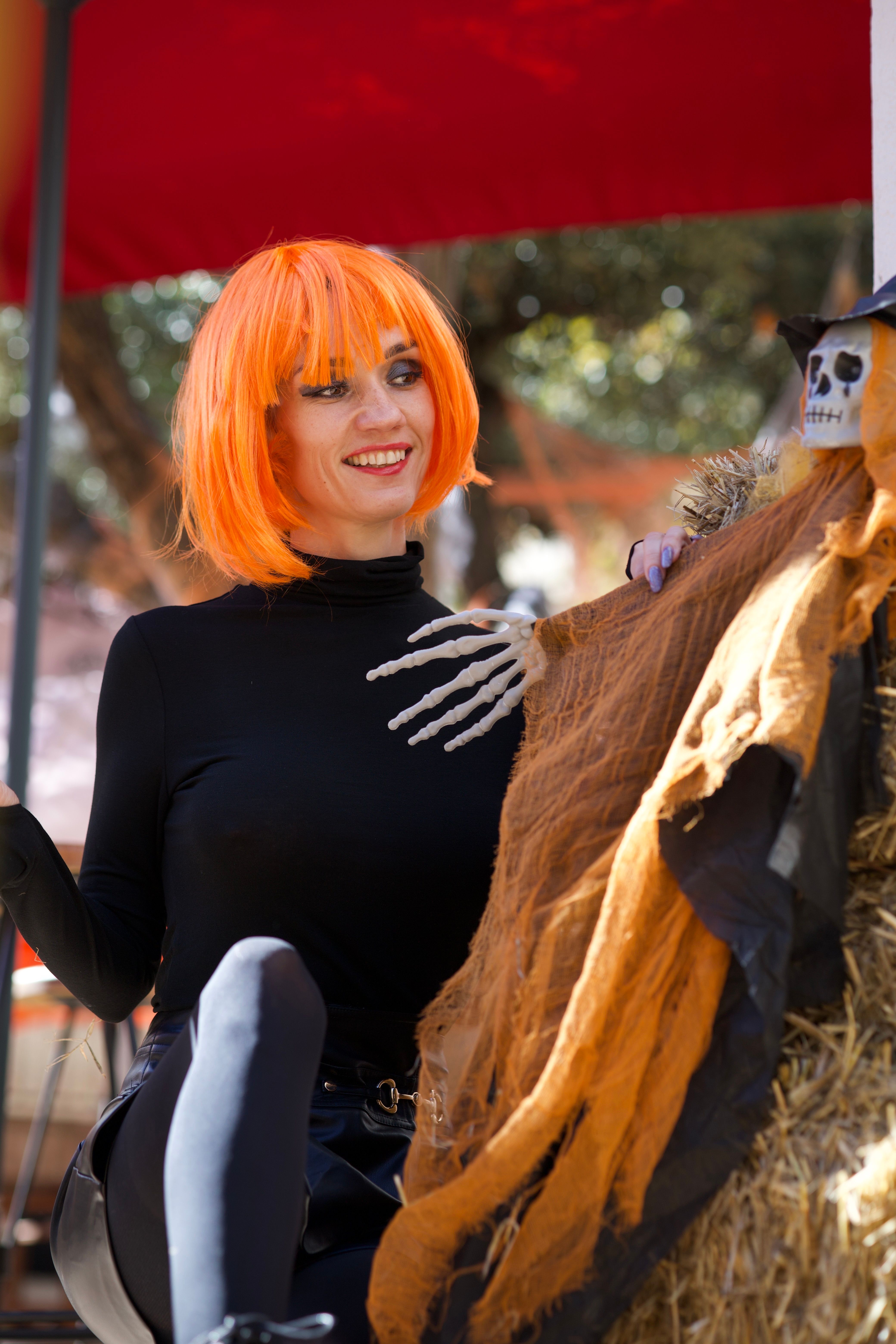 Woman in Halloween Costume with Skeleton Decor