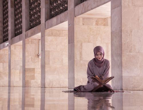 Free A woman reading the Quran inside a mosque in Jakarta, Indonesia, reflecting a serene moment of devotion. Stock Photo