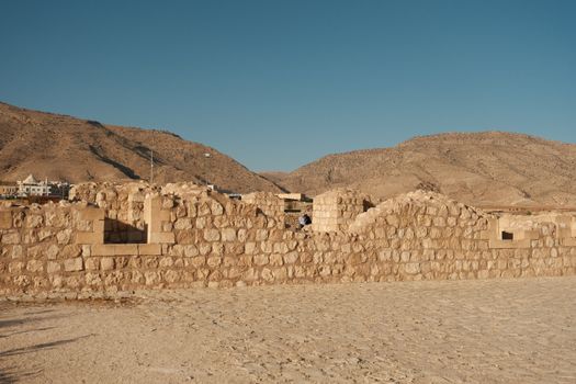 Explore the rustic beauty of an ancient stone wall in Batman, Türkiye, surrounded by arid mountains.