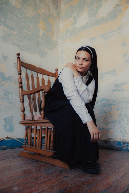 Contemplative Rocking Pensive Nun in Vintage Room with Rocking Chair · Free Stock Photo