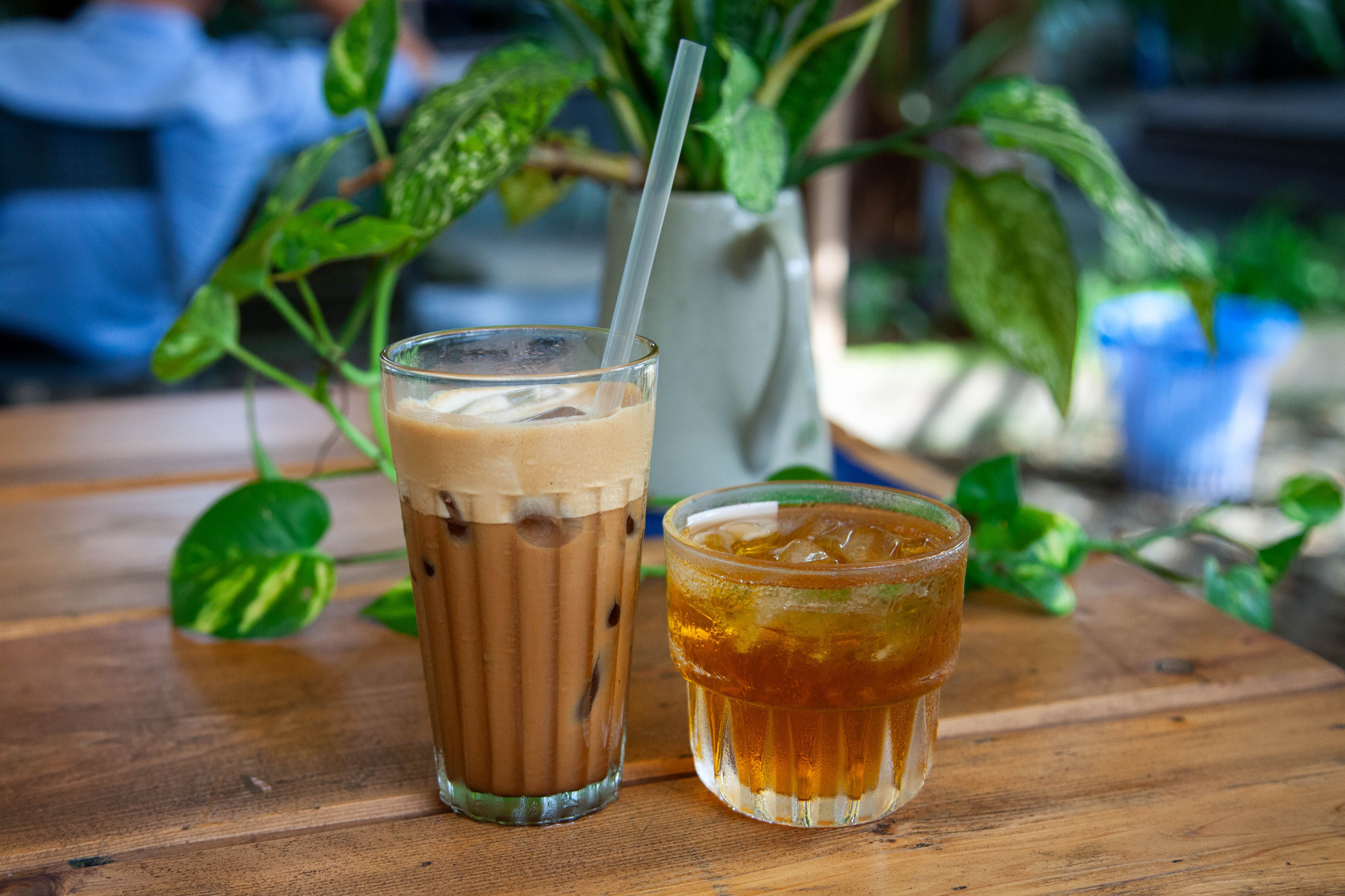 Glass of homemade cold brew tea garnished with lemon and mint