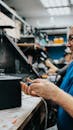 Technician Working in Electronics Repair Shop