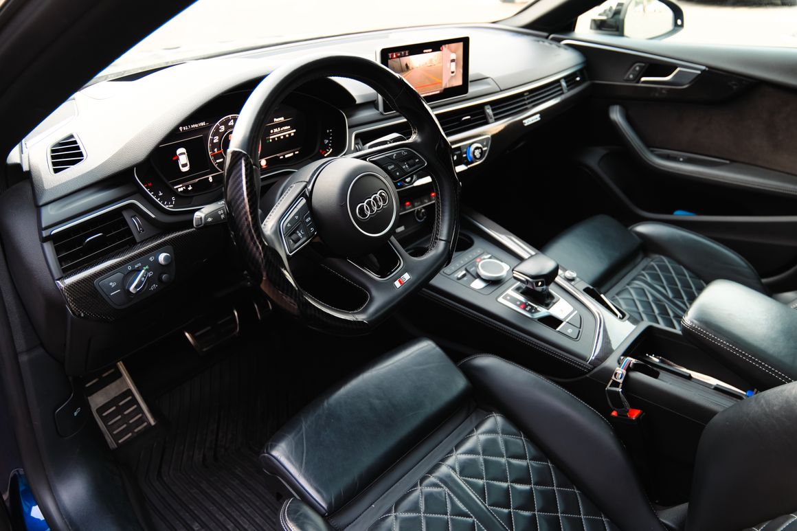 Modern luxury car interior with black seats and dashboard