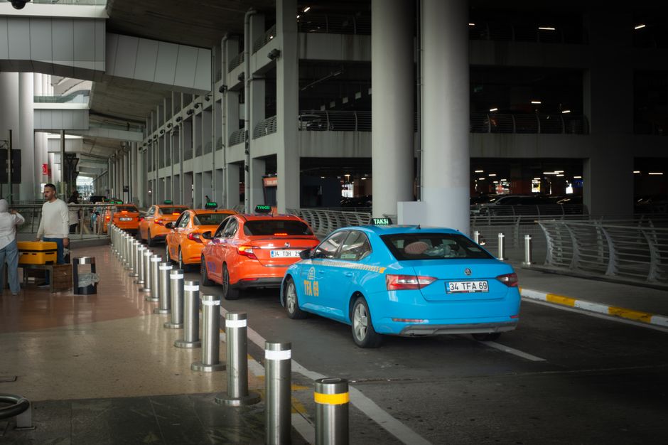 Taxi stand at Marrakech airport with beige taxis waiting