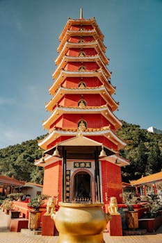 Bright red pagoda at the Ten Thousand Buddhas Monastery in Hong Kong, captured under clear blue skies.