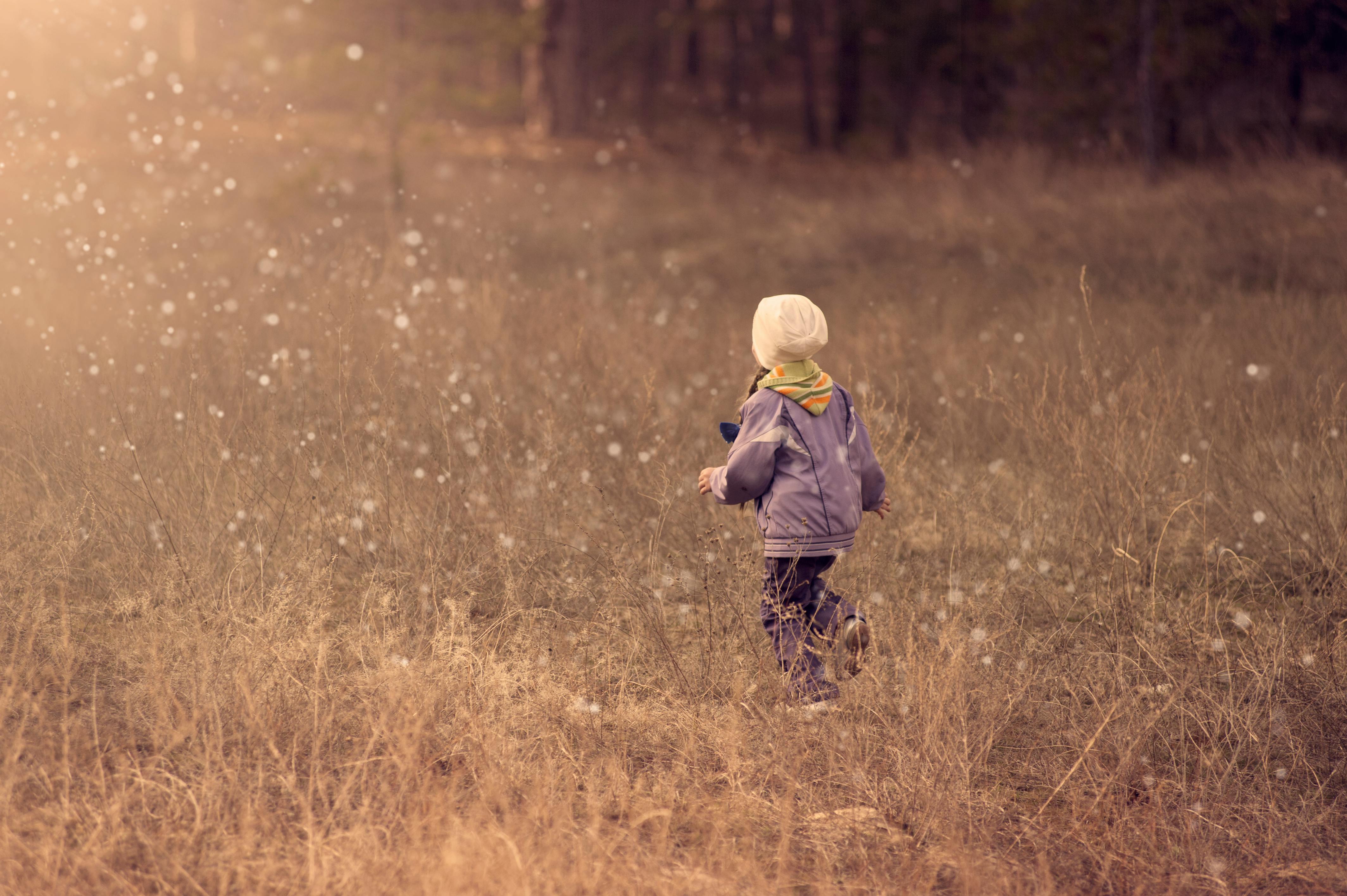 child walking on grass path