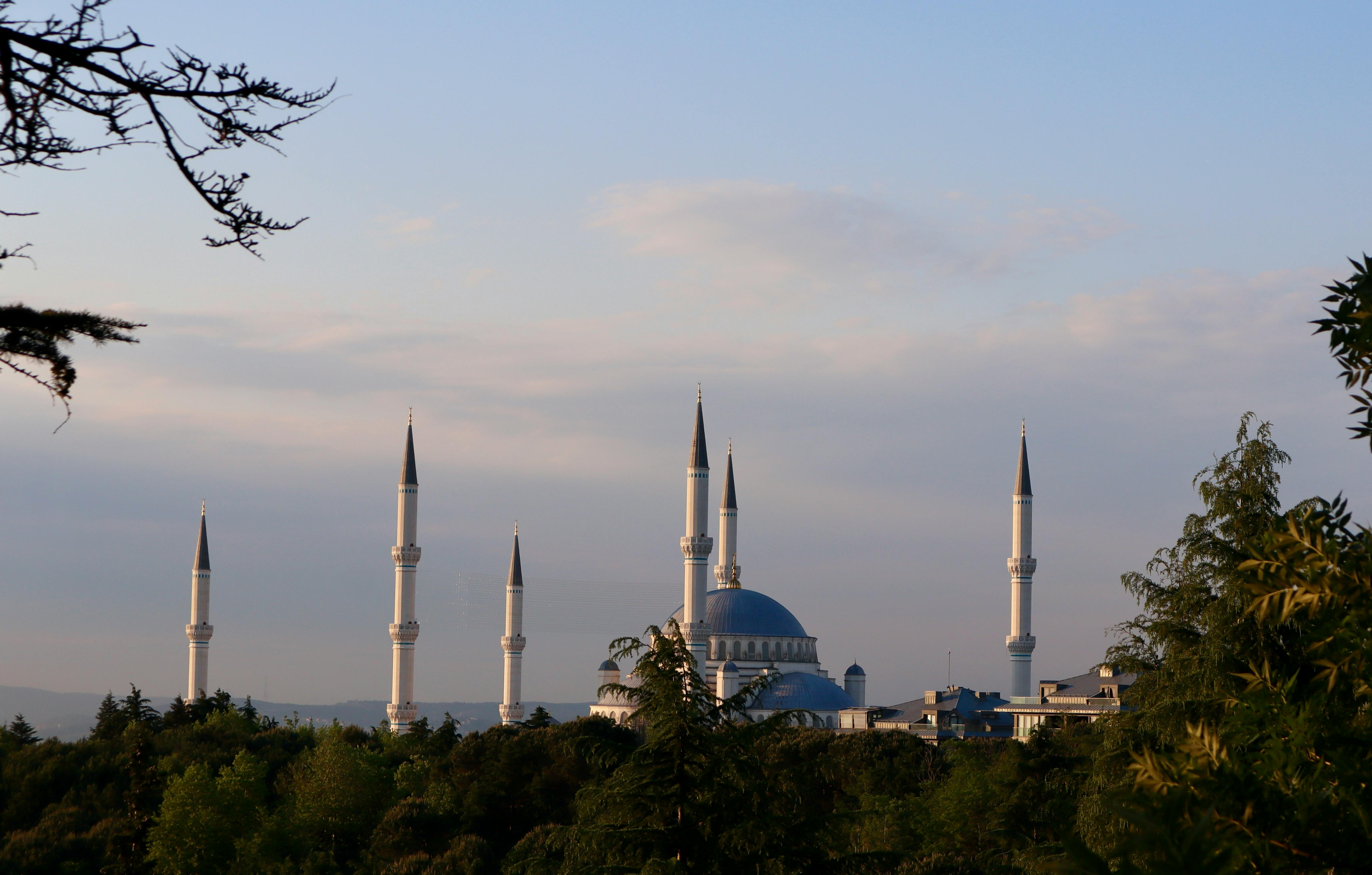 Scenic view of a beautiful mosque's silhouette with minarets against an evening sky in Istanbul.
