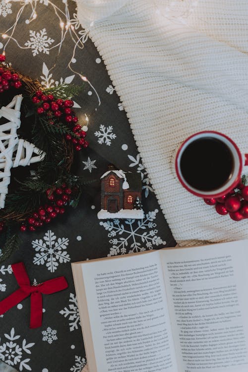 Free Homey composition of Christmas attributes with open book and coffee Stock Photo