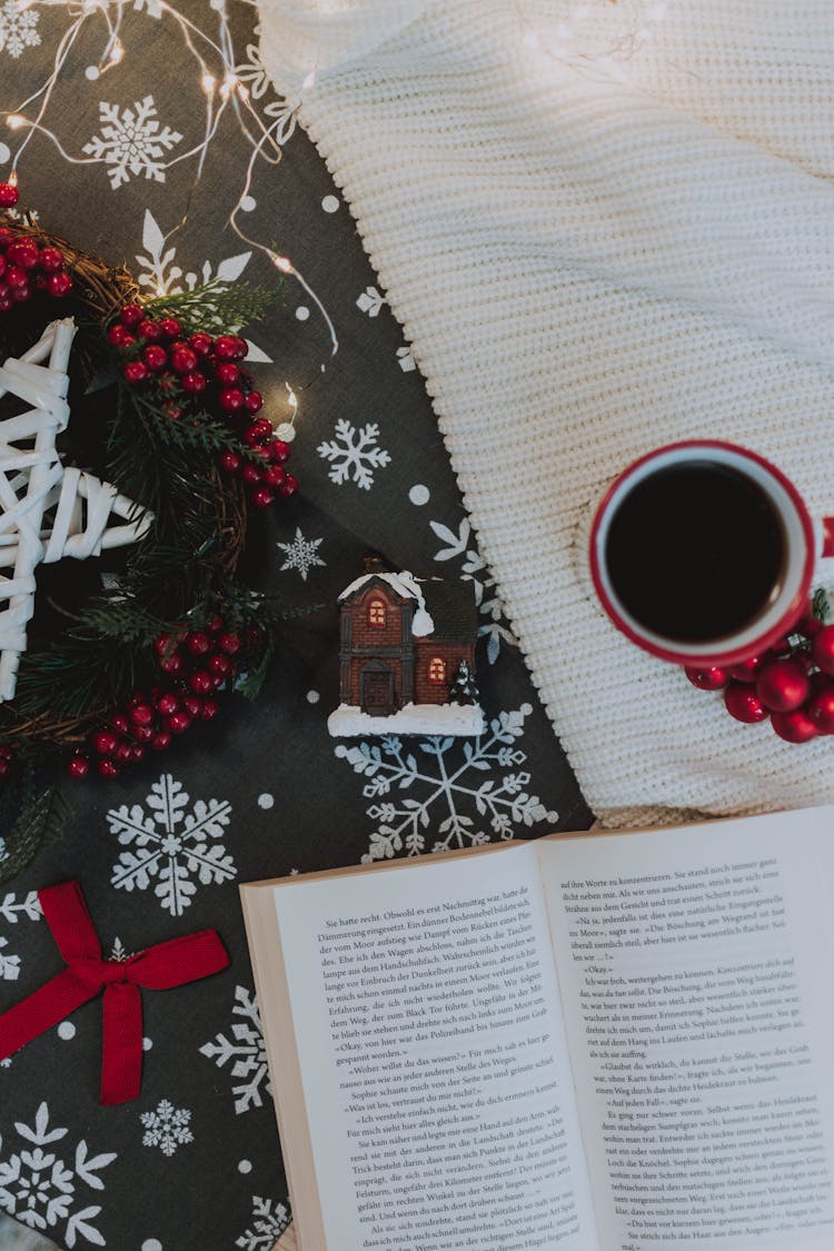 Homey Composition Of Christmas Attributes With Open Book And Coffee