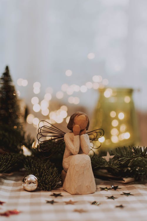 Photo Of Angel Figurine Near Christmas Ball