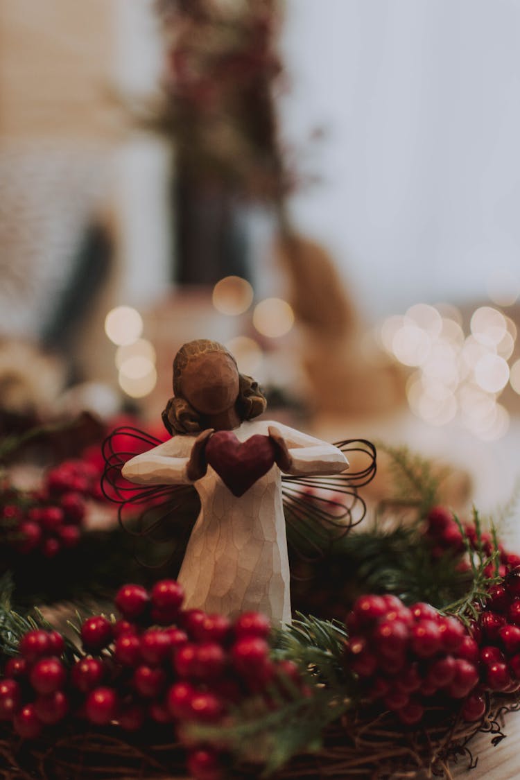 Photo Of Angel Figurine Standing On Garland