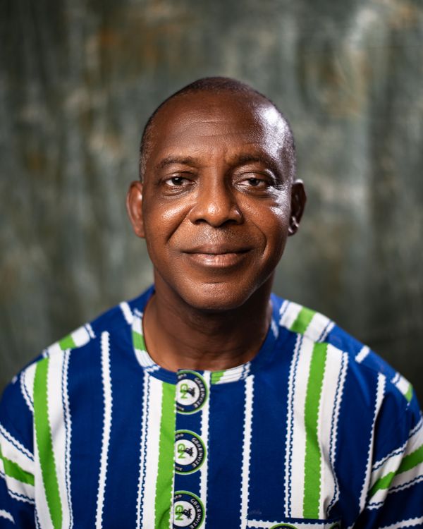 Portrait of a Smiling Mature Man in Traditional Attire · Free Stock Photo
