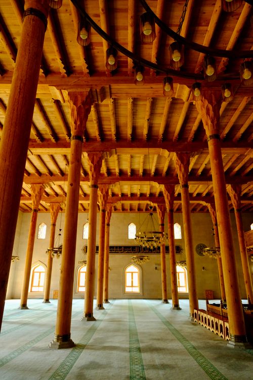 Free Stunning mosque interior showcasing wooden columns and arches in serene lighting. Stock Photo