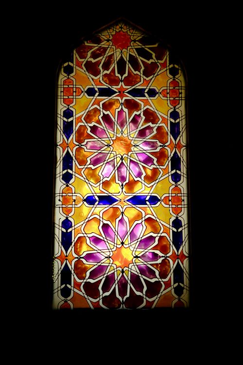 Free Vibrant stained glass window featuring intricate geometric patterns. Stock Photo