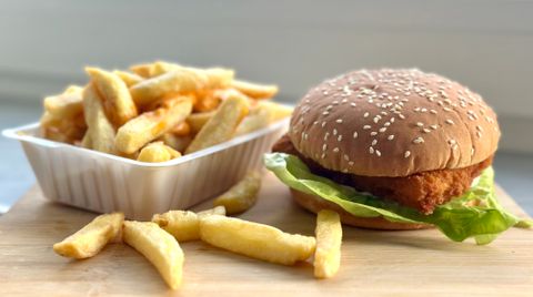 Crispy chicken sandwich on a seeded bun with fries — photo by Mariam x on Pexels