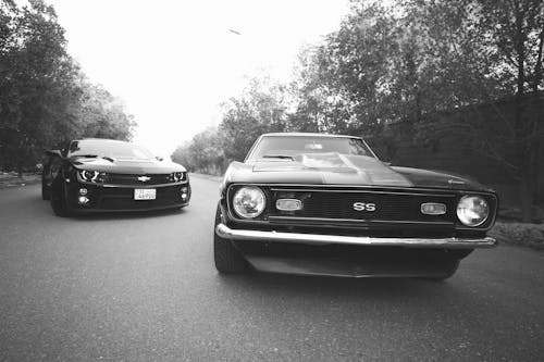 Modern and retro cars on asphalt road