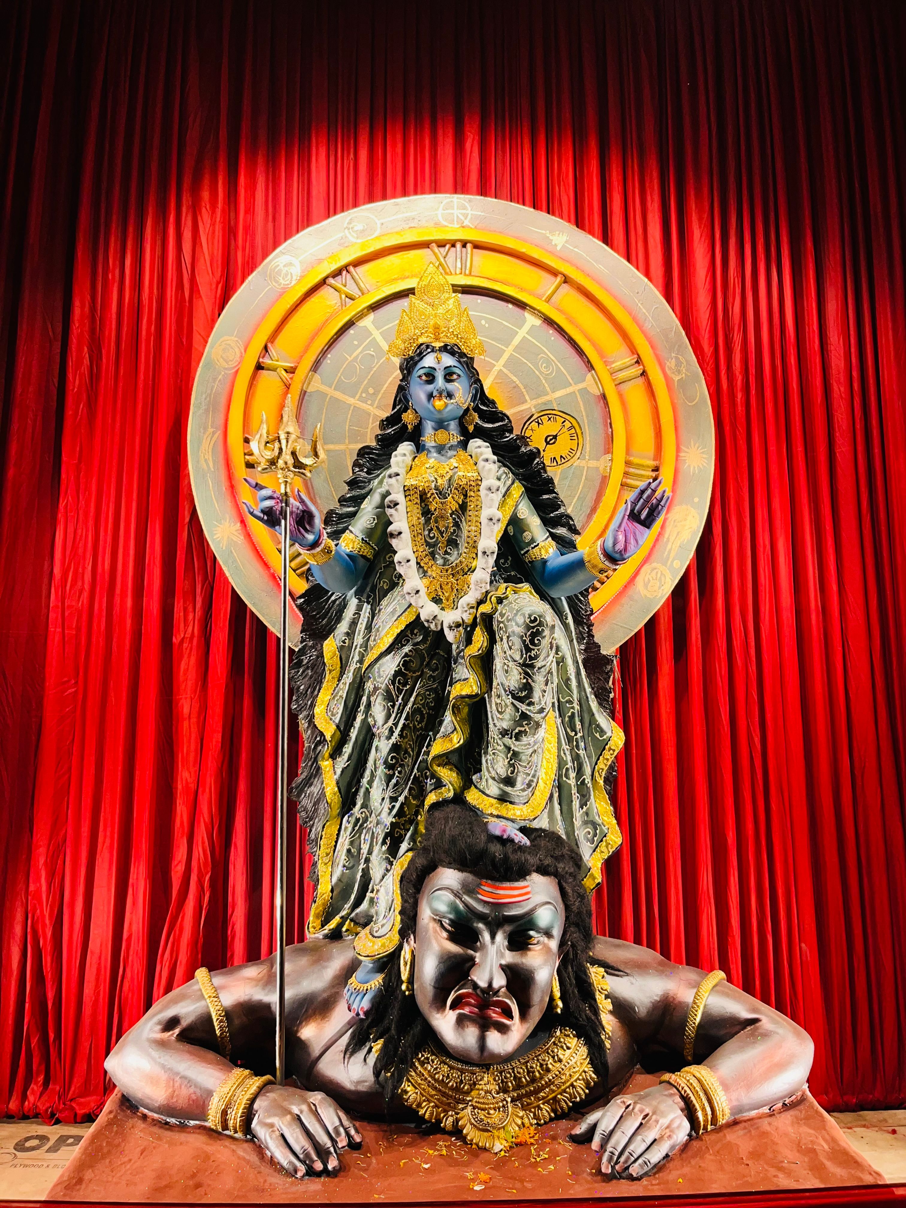 Vibrant sculpture of Goddess Kali in an Indian temple with traditional backdrop.