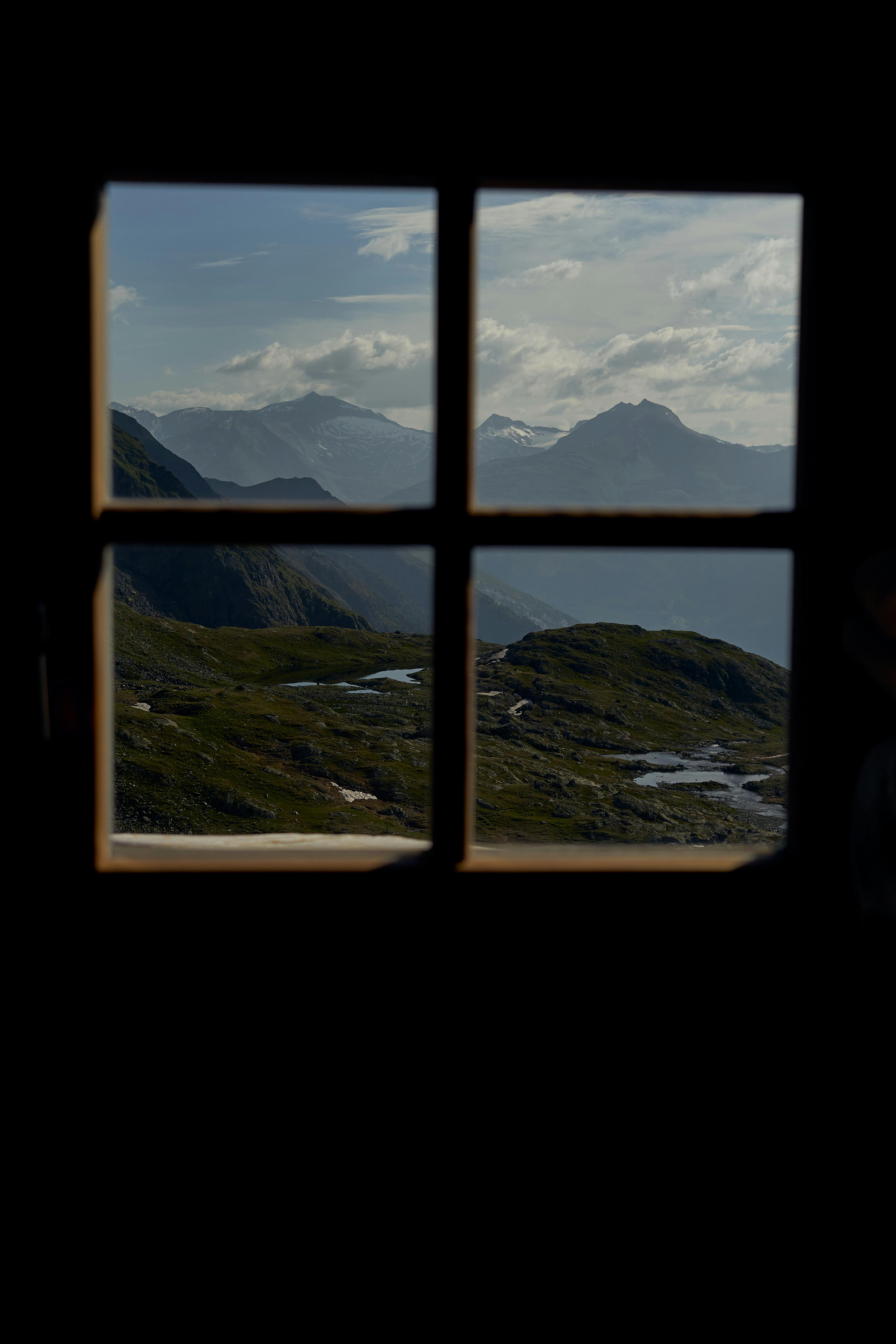 Majestic mountain landscape viewed through a window, capturing natural beauty and tranquility.