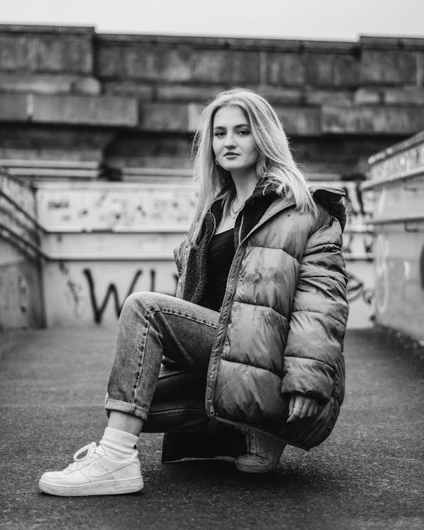 Grayscale Photography of Woman Wearing Zip-up Bubble Jacket