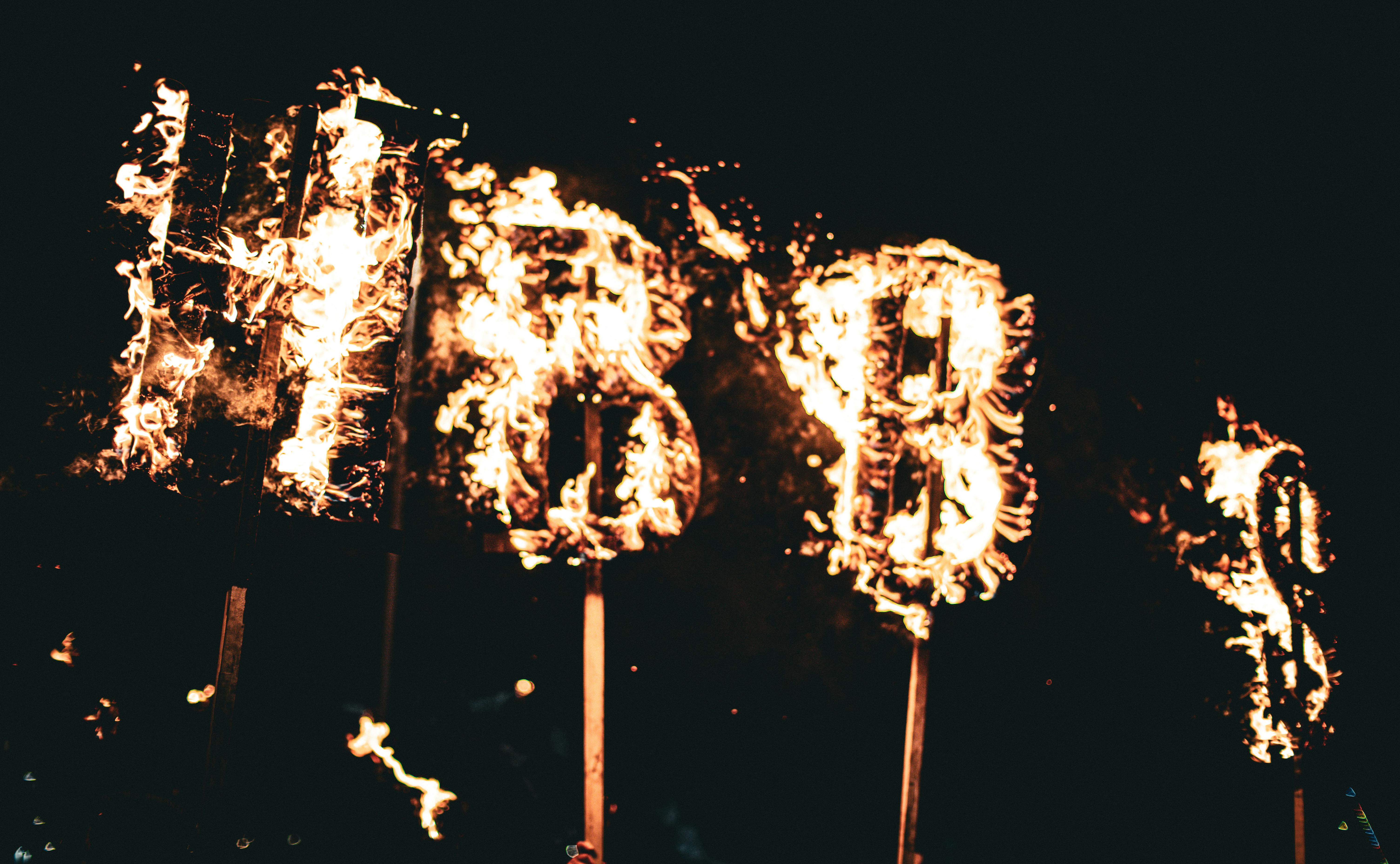 Gratis Dramatisk nattbilde av bokstaver i brann, som skaper en surrealistisk og varm glød. Arkivbilde