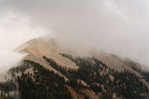 Free Fog envelops the La Sal Mountains in Utah, showcasing autumnal beauty and serene landscapes. Stock Photo