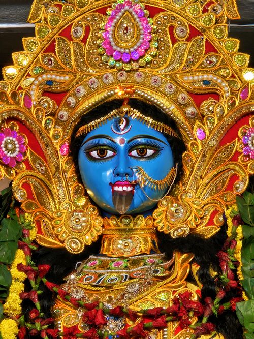Free Close-up of a vibrantly colored Kali statue with intricate gold detailing, symbolizing divine power. Stock Photo
