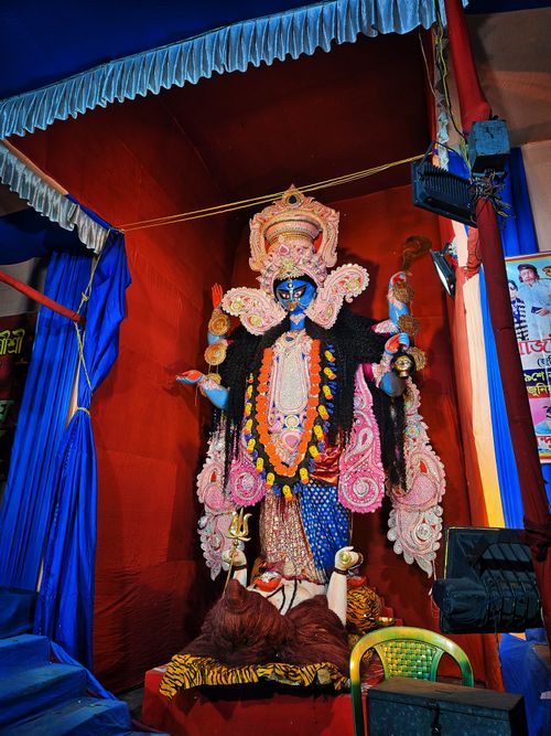 Free Colorful statue of Hindu Goddess Kali adorned for a festival indoors. Stock Photo