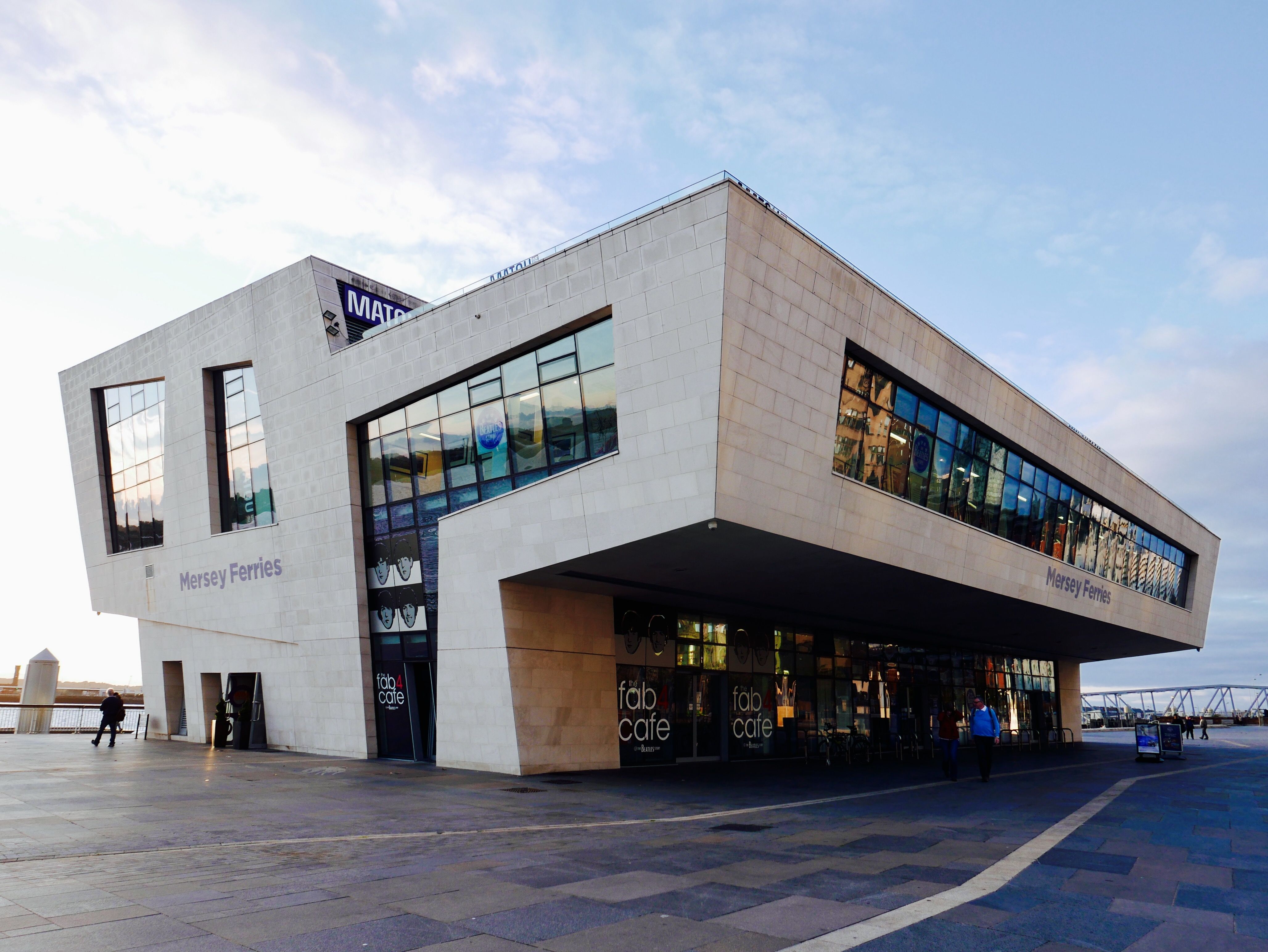 Contemporary architecture of Mersey Ferries terminal in Liverpool with a clear sky.