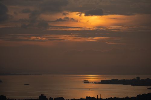 Free A breathtaking sunset view over İzmir Bay with golden hues reflecting on the water. Stock Photo