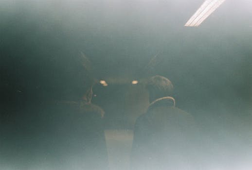 A mysterious analog film photo of two people in İstanbul's subway, evoking a vintage mood.