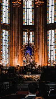 A breathtaking view of a Gothic church interior showcasing stained glass windows and an altar.