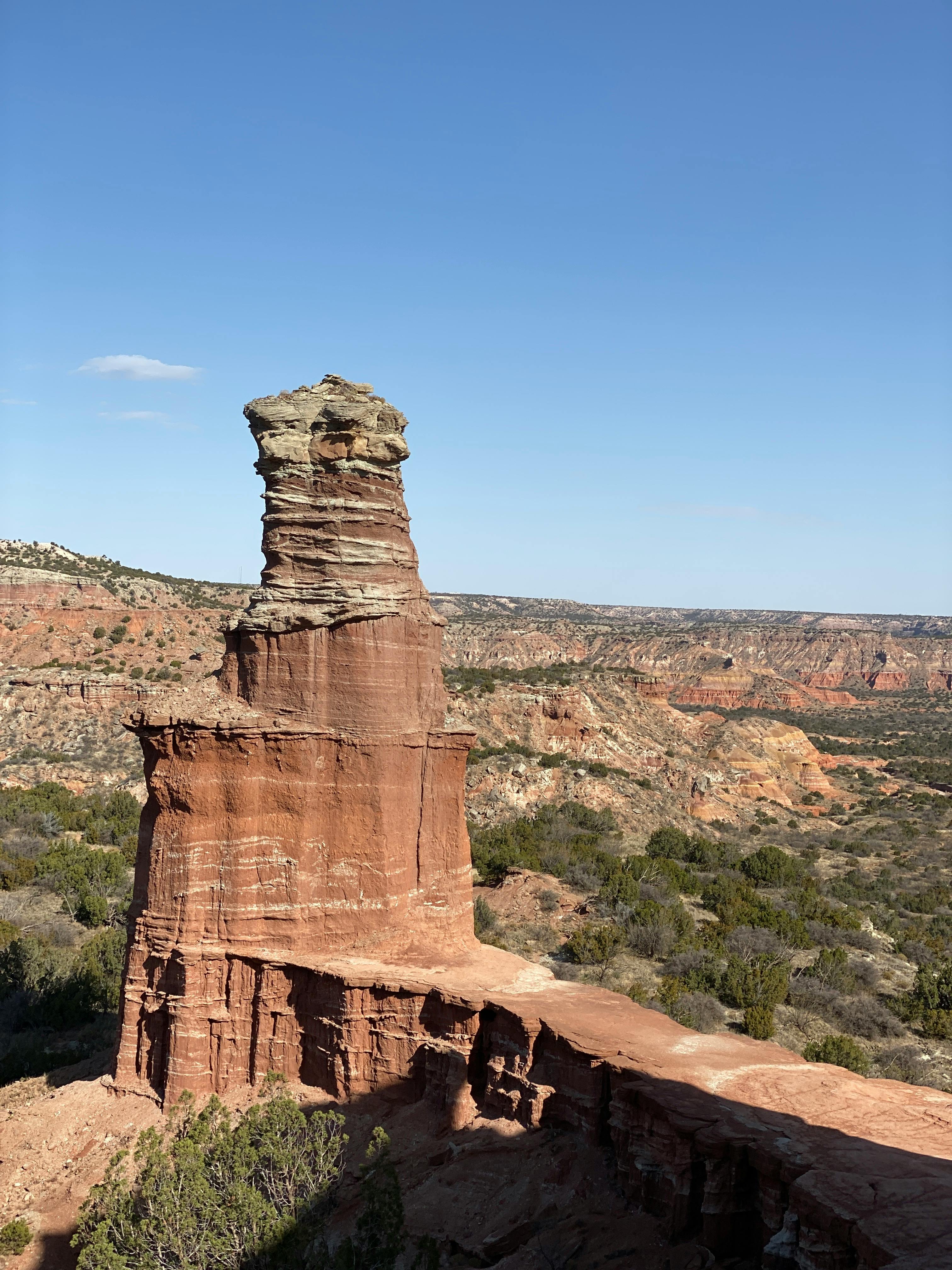 Captivating natural rock formations in Palo Duro Canyon, Texas under a clear blue sky.