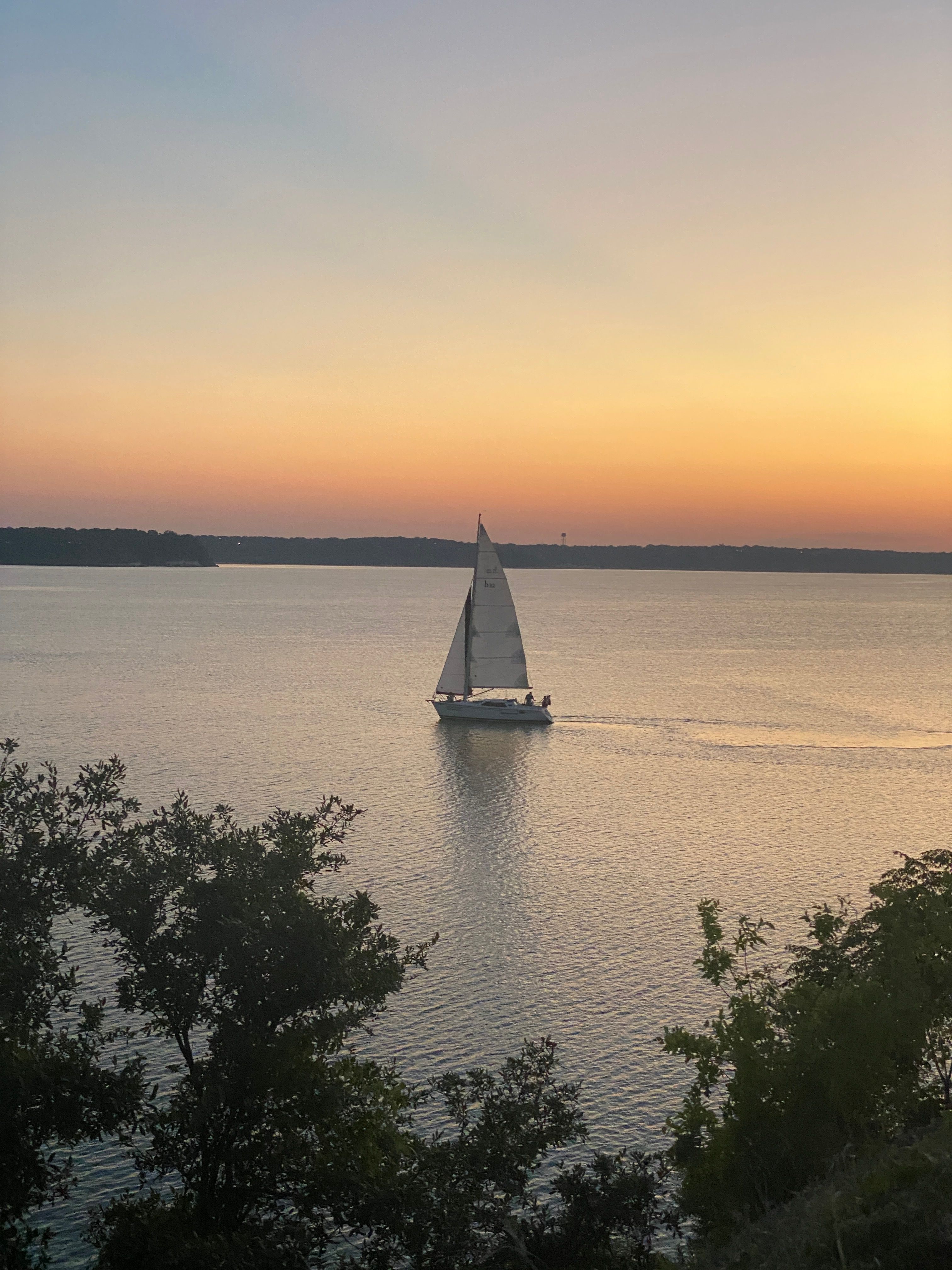 Sailboat at sunset on a tranquil Texas lake near Wylie — Lake Lavon lifestyle