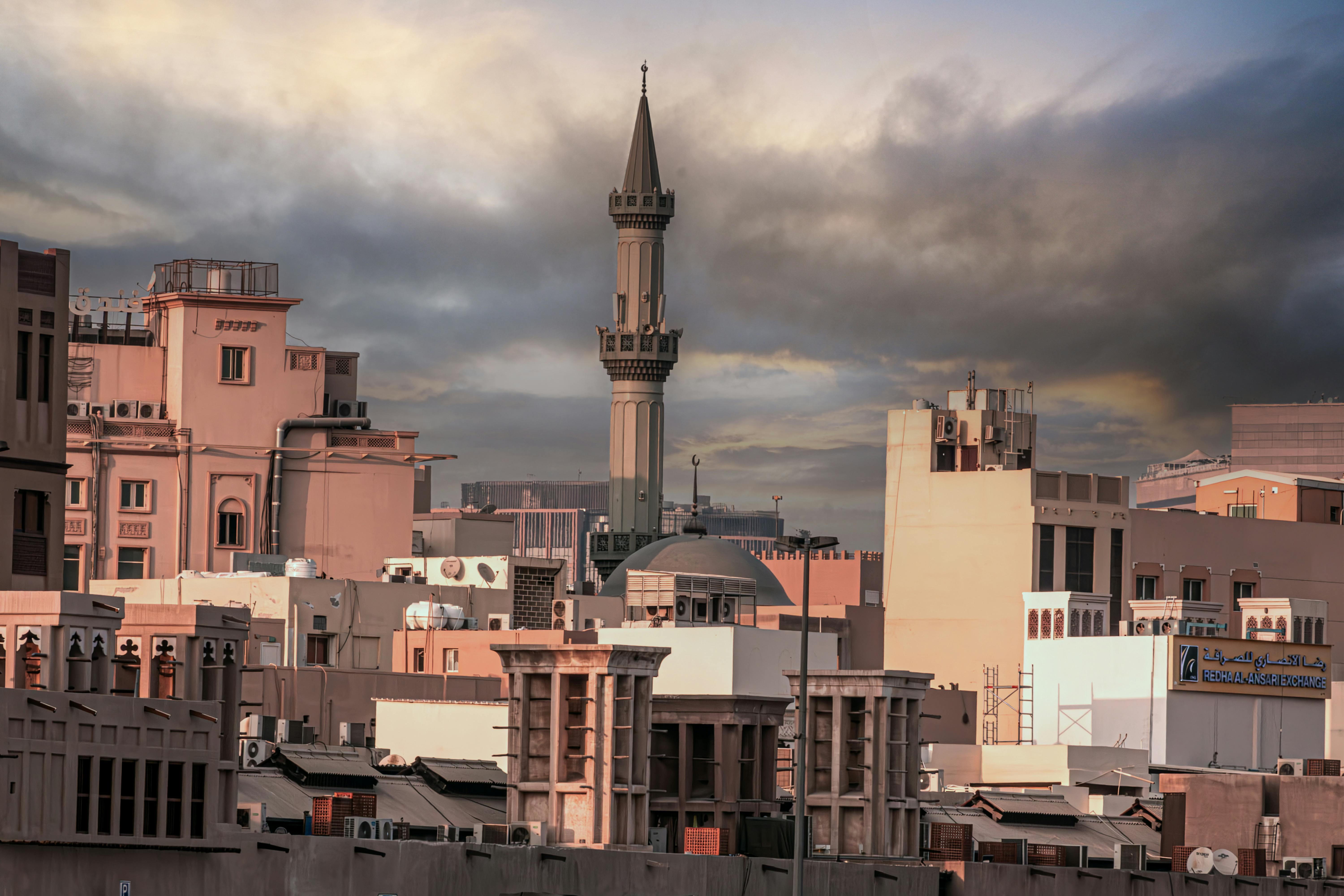 Dramatic skyline of Dubai with traditional and modern architecture at twilight.