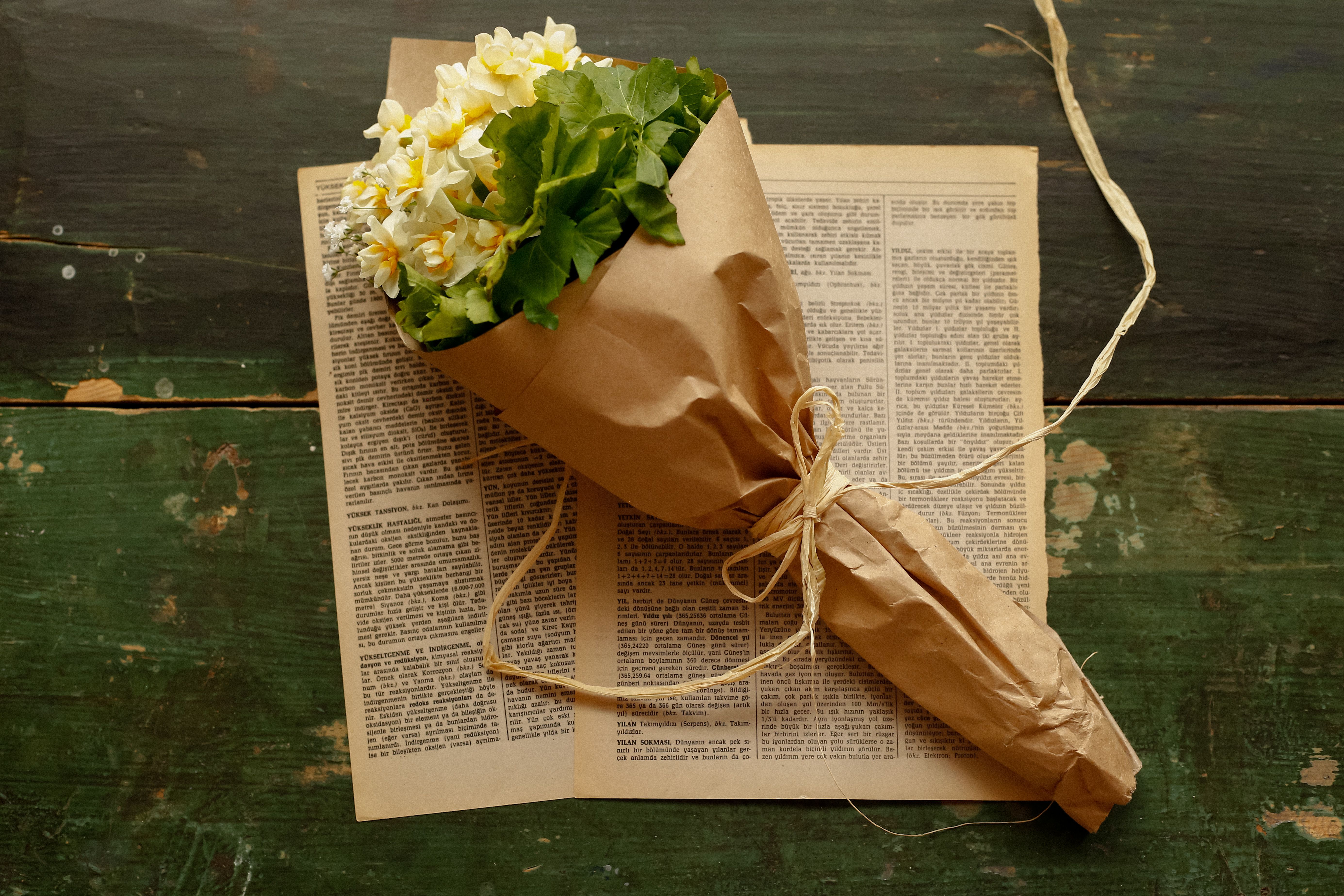 Rustic Bouquet on Vintage Newspaper Background · Free Stock Photo