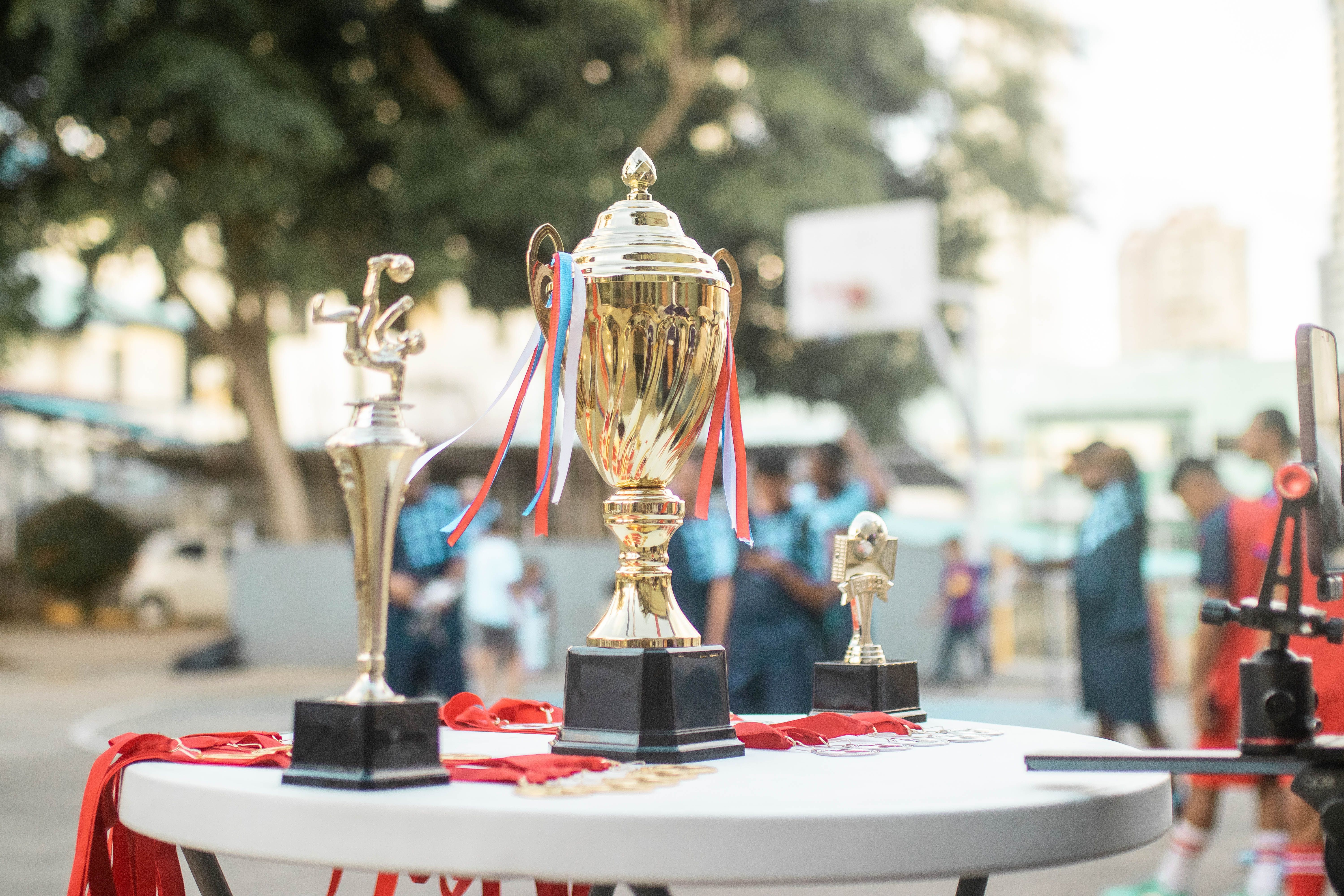 Golden Trophy on Display at Outdoor Sports Event · Free Stock Photo