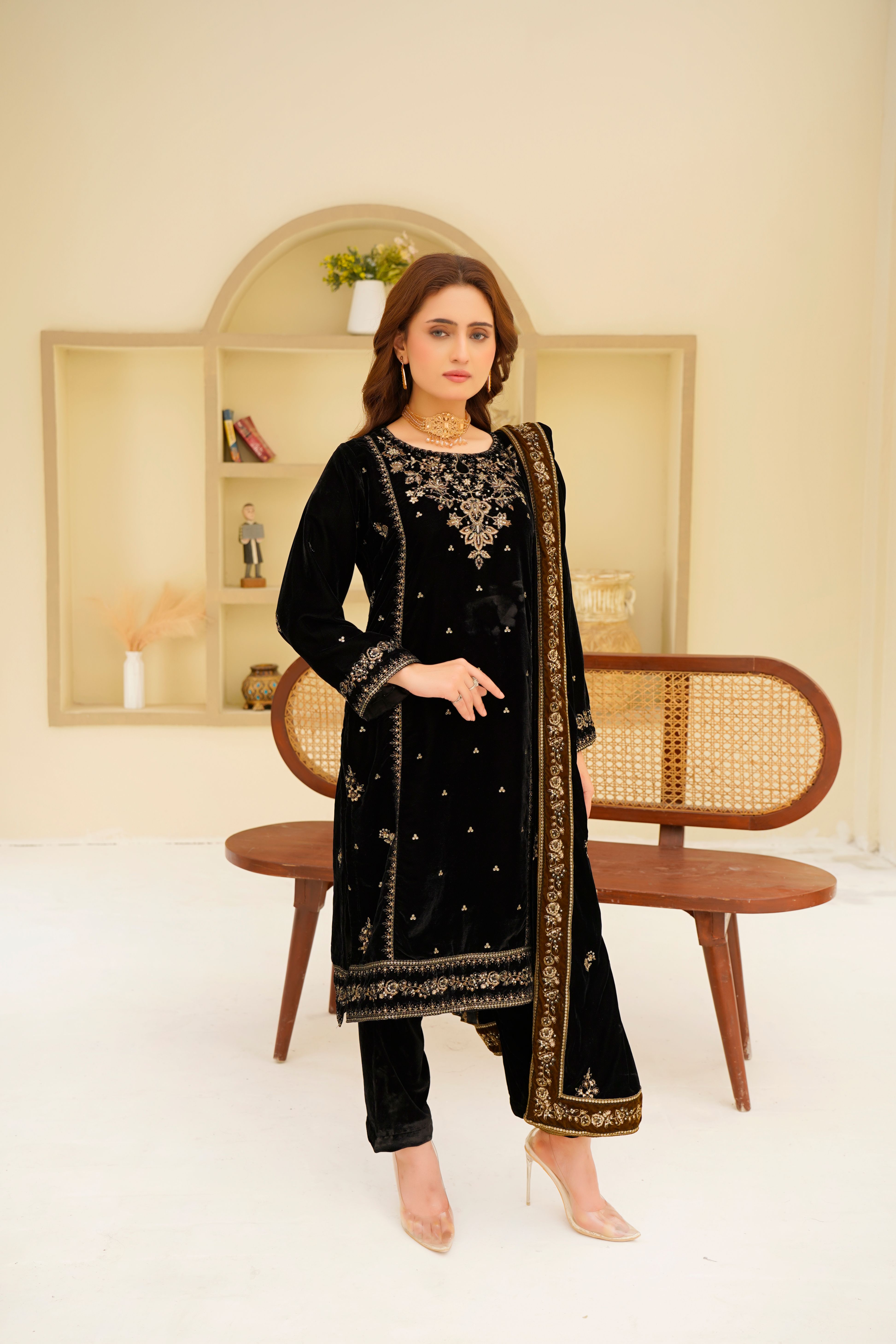 Stunning portrait of a woman in an exquisite black velvet traditional dress, showcasing cultural fashion.