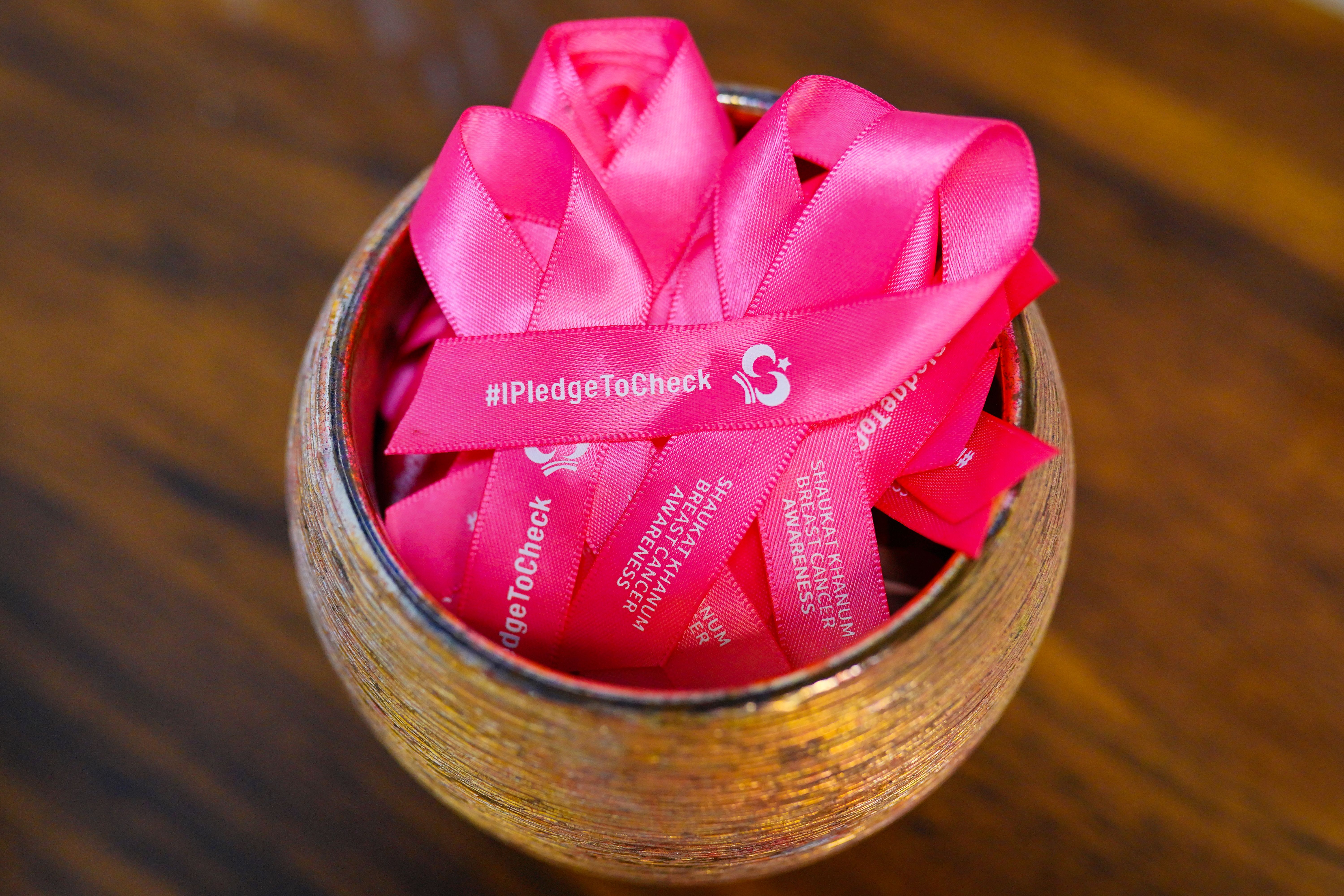 Pink Breast Cancer Awareness Ribbons in Bowl · Free Stock Photo