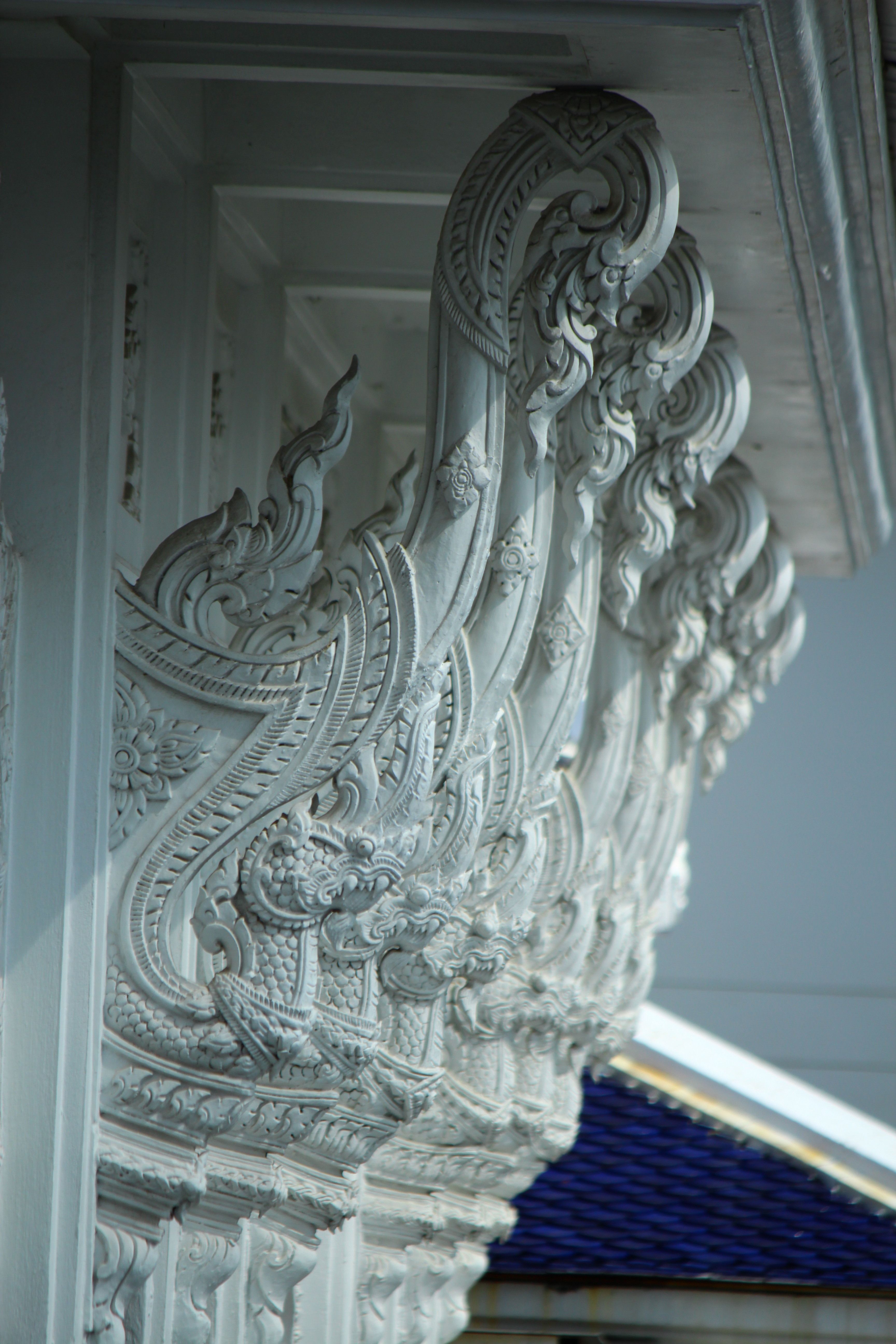 Close-up of carved architectural elements on a temple exterior showcasing traditional artistry.