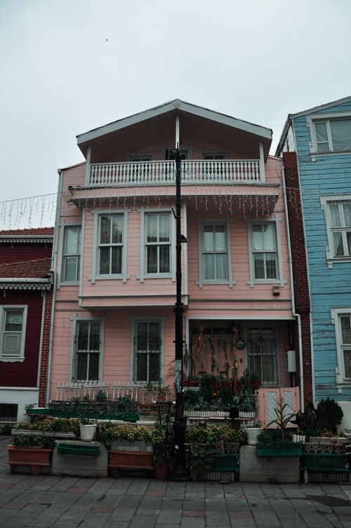 Free Captivating street view of a quaint pink house with a decorative facade. Stock Photo