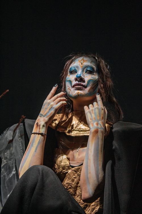 Free Artistic portrait of a woman with Dia de Muertos makeup, dramatic lighting. Stock Photo