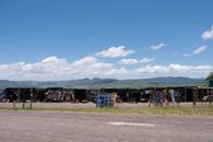 Colorful market stalls in the South African countryside with scenic mountain views.